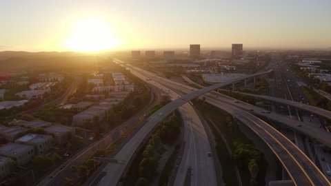 Sunset aerial view of the Irvine, California skyline and the 5 and 405 freeway interchange.