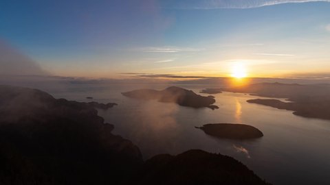 Timelapse. Beautiful View of Canadian Mountain Landscape during a colorful sunny sunset. Taken on St. Mark's Summit, West Vancouver, British Columbia, Canada. Nature Background