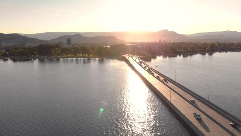 Aerial footage of bridge leading to Downtown Kelowna on Lake Okanagan at sunrise with beautiful light. 4K 24FPS.