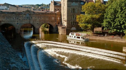 BATH, circa 2020 - Golden hour view of the Pulteney Bridge crossing the River Avon in Bath, Somerset, England, UK, on a bright sunny day