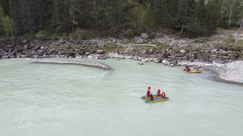 Video filming from a drone, the beautiful mountain river Argut and sportsmen rafters on a catamaran overcome the dangerous river rapid "Gate". Altai mountains and clean air. Altai Republic, Russia