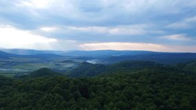 Beautiful drone panoramic view of green forest on the mountains. Summer day. 4k nature video. Awesome Dramatic sky, rainy clouds.