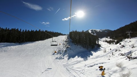 POV of riding Sterling Express ski lift on a sunny day