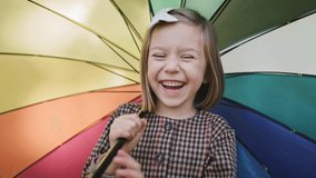 Handheld view of charming girl with umbrella
