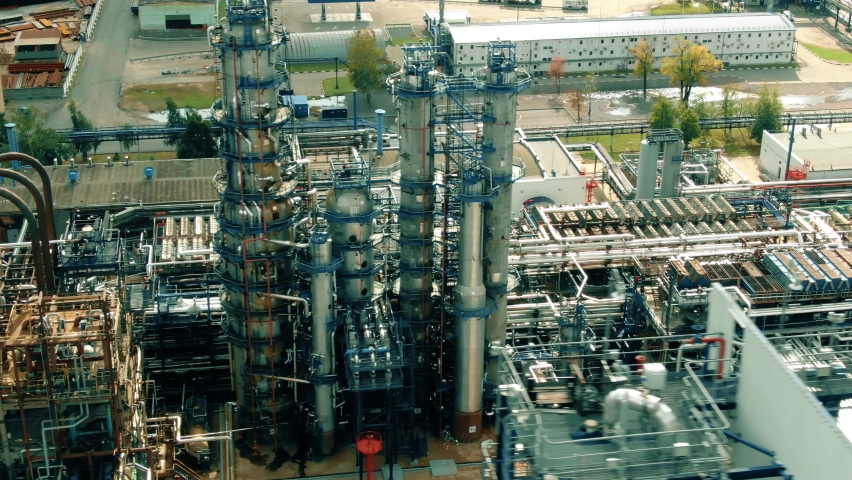 Aerial view of an oil refinery distillation columns or towers used for gasoline production Royalty-Free Stock Footage #1059903035