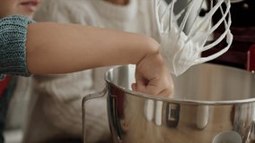 Video of child tasting sugar paste during Christmas baking. Shot with RED helium camera in 8K.