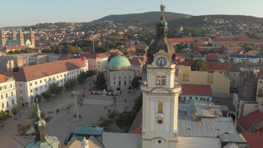 Aerial / drone footage of Széchenyi square of Pécs, the fifth largest city of Hungary, a major cultural center of Hungary, on the slopes of Mecsek mountains, administrative center of Baranya County