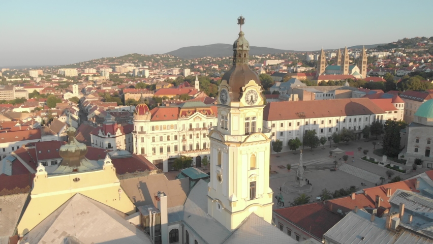 Aerial / drone footage of Széchenyi square, Pécs, the fifth largest city of Hungary, a major cultural center on the slopes of the Mecsek mountains, administrative and economic center of Baranya County