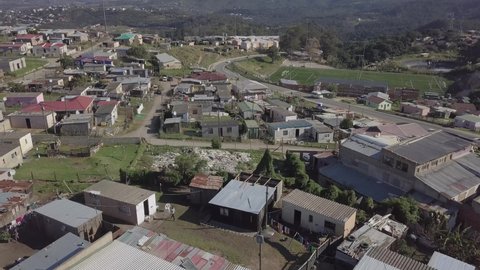Aerial: Knysna Township flight to soccer field in Flenders, S Africa