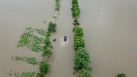 Aerial view flooded road heavy rain flooding taken during drone flight overflowing river storm water, danger wet disaster damage grass, climate lake high stream season environmental ecology rural