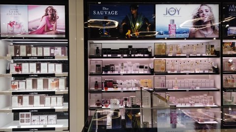 Moscow, Rissia - October 07, 2019: People in the Perfume and cosmetics shop in the duty free market at the airport. Shelves with famous brands cosmetics. Luxury shopping concept.