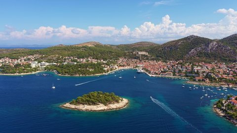 Aerial footage of the famous Hvar bay and island with the historic old town in Croatia in the Balkans