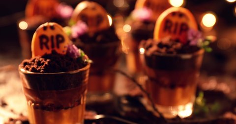 Graveyard chocolate mousse cups with tombstone cookies, halloween dessert