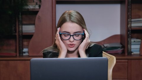 Frustrated young business woman feel stressed look at computer screen worried of problem read bad online news receive failed exam results concept sit at home office table