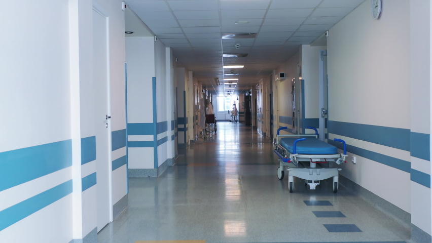 Medical bed on wheels in the hospital corridor.  Royalty-Free Stock Footage #1059922769