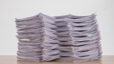 Stop motion animation Stacks overload document paper files on office desk, Business concept.