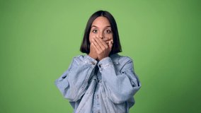 woman covering mouth with hands. Can not speak on green screen chroma key background
