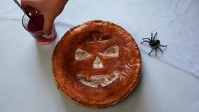 Hand of baker putting decorations on table near halloween pumpkin pie - Powered by Shutterstock - Get 15% off with code: PIKWIZARD15