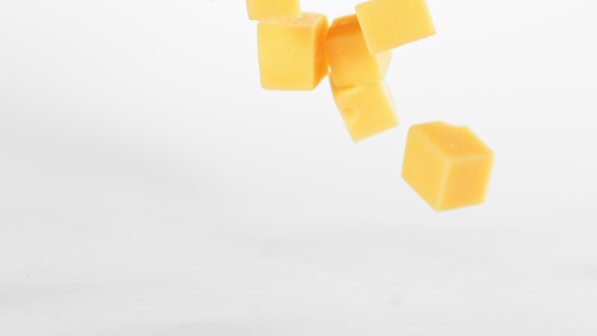 Super Slow Motion Shot of Cheese Chunks Falling on White Background at 1000 fps. | Shutterstock HD Video #1059940031