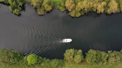 4k aerial moving sideways above boat cruising on The River Thames, Berkshire, UK