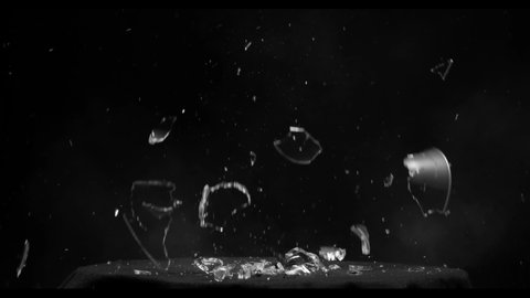 Effect of a martini glass shattering from a gun shot over a black background from the Fragment collection - Glass VFX Video Element.