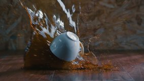 slow motion of hot coffee cup spilling onto the wooden floor and coffee water splash on dark background, B-Roll Footage - Powered by Shutterstock - Get 15% off with code: PIKWIZARD15