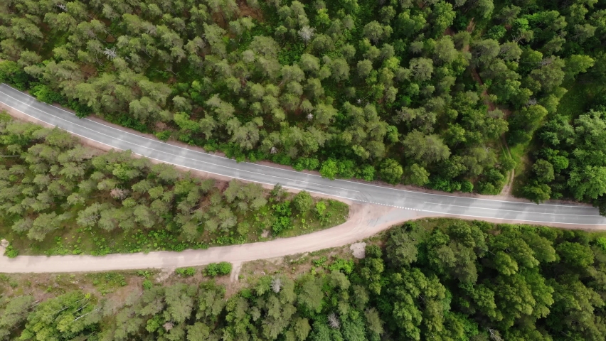 crossroads of two roads in the forest. lonely car. Summer. Aerial view from top down. Flying over. Drone is moving forward Royalty-Free Stock Footage #1059951716