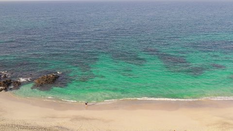 Al Sifah / Oman - 07 12 2019: Oman tourism turquoise beach with camping tents aerial