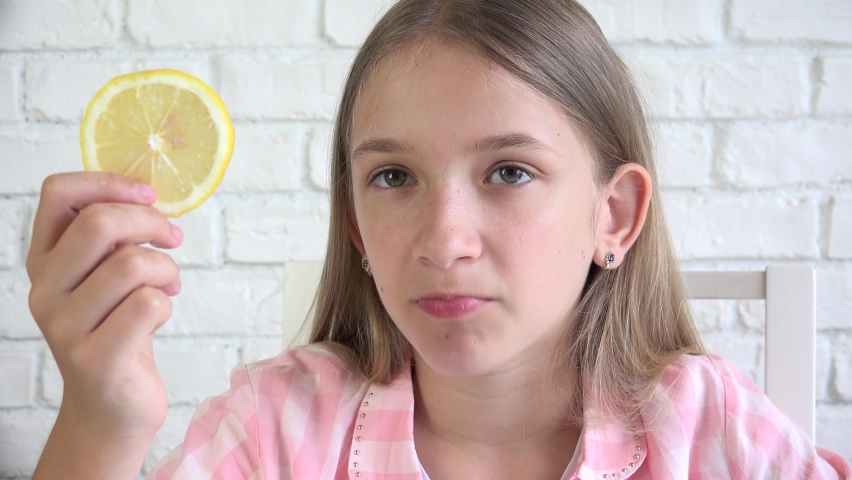 Child Eating Lemon, Child Eats Fruits, Young Girl at Breakfast in Kitchen, Children Healthcare | Shutterstock HD Video #1059972401