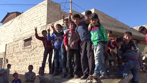 A group of children stand on top of a tank cheering the victory of the Free Syrian Army fighters over ISIS.
Aleppo, Syria 14 March 2017