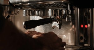 barista make hot black espresso in coffee machine