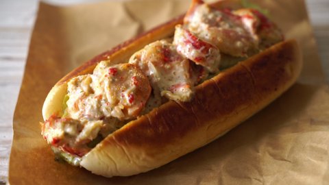 homemade lobster roll with chips and sauce