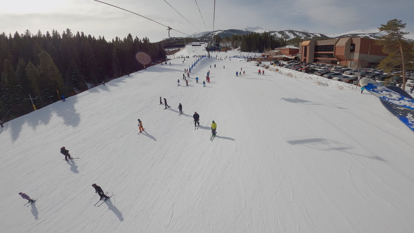 Video footage of skiers and snowboarders, taken from the ski lift. The footage was captured in Breckenridge, Colorado.