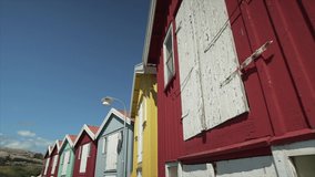 Smögen pier smooth gimbal shot of colorful buildings. Sunny day with blue sky in Sweden Bohuslän Swedish coast. Tourist attraction sight. Slow motion walking video