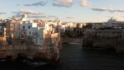 Aerial sunset view of the Polignano a Mare town, Puglia region, Italy, Europe. Superb view of Adriatic sea. Traveling concept background. Turquoise sea water.