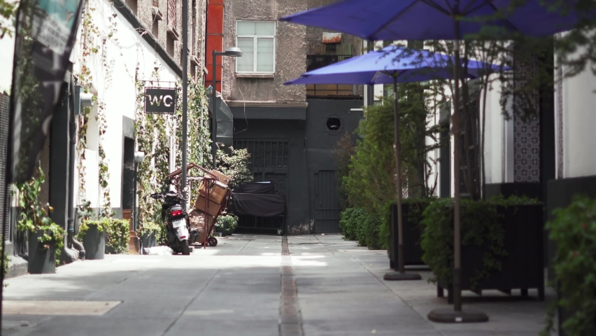Motorcycle Parked Outside a Public Restroom in an Alley