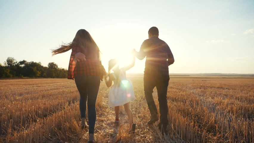 happy family run in field throw up their daughter. kid dream concept. daughter and parents run across wheat field near park. happy family dream of happiness. kid child and parents run in the park fun Royalty-Free Stock Footage #1059998087