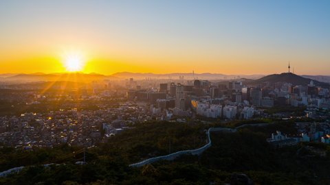 Panning Time lapse Landscape of Seoul South Korea in the morning and the golden sun shines on the city.