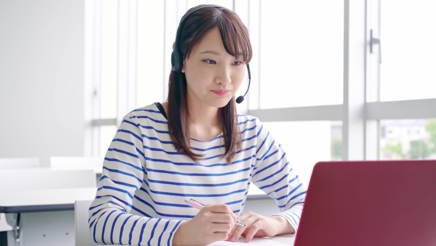 Young asian female student taking online lessons. Royalty-Free Stock Footage #1059999689
