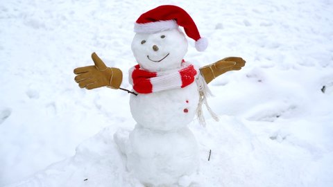Happy funny snowman in the snow. Making snow man and winter fun