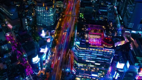 A night timelapse of the neon town in Shibuya Tokyo high angle wide shot panning