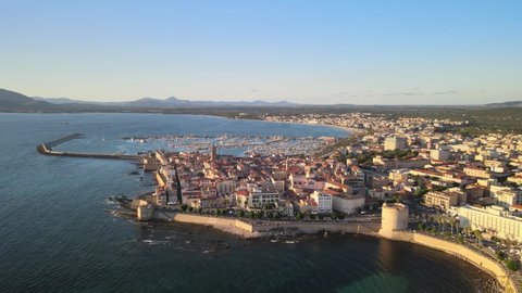 Footage from the drone with upward movement of the stortic center of the city of Alghero overlooking the sea