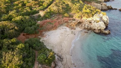 shot from the drone of a small and paradisiacal deserted beach near Alghero Sardinia