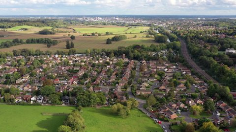 4k aerial footage sideways near suburban housing and train line on the outskirts of Reading, Berkshire, UK