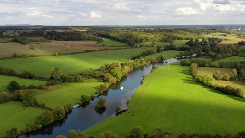 4k aerial above a boat on The River Thames at Mapledurham near Reading, Berkshire, UK