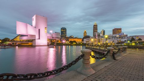 Cleveland, Ohio, USA downtown city skyline and harbor from dusk to night on Lake Erie. 