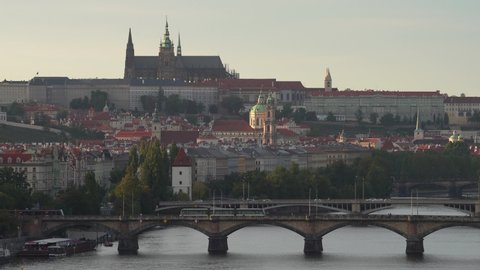 
Prague Castle and St. Vitus Cadetral at sunset the sun over the Vltava River and the Charles Bridge in the middle of Prague