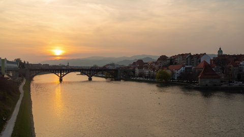 Maribor, Slovenia : Beautiful Slovenian City Fairy Tale Old Town Bridge on River Drava Cityscape Sunset Time Lapse