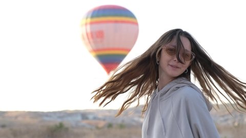 Girl gets happy when she sees flight hot air balloons in Cappadocia. Turkey  Cappadocia 4K 