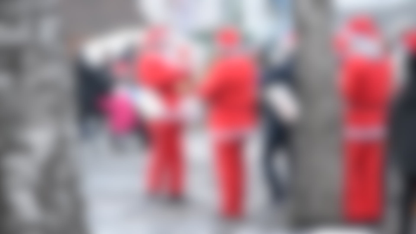 Blurred background. Orchestra of Santa Claus on street. The orchestra